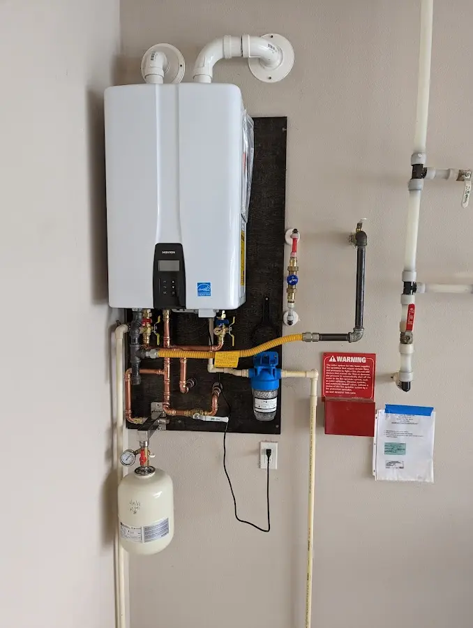 Professional plumber installing copper piping in a Steele Creek home